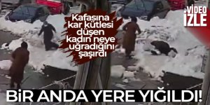 Yolda yürüyen kadının kafasına kar kütlesi düştü